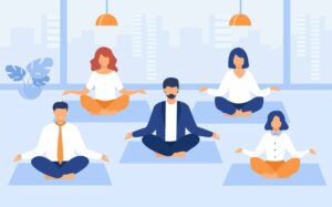 Employees participating in a group wellness activity like yoga or mindfulness as part of a workplace wellness program.